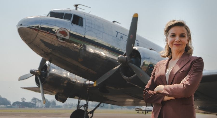 justine clarke australia come fly with me standing in front of plane