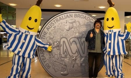 Tony Armstrong with Bananas in Pyjamas alongside ABC commemorative coin