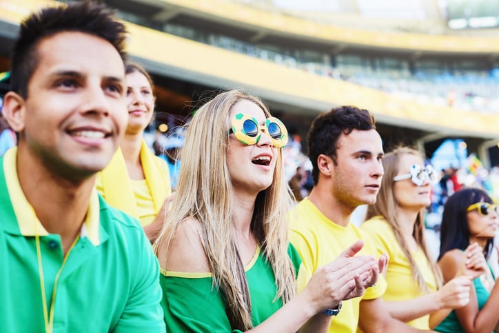 Smiling soccer fans watching a match