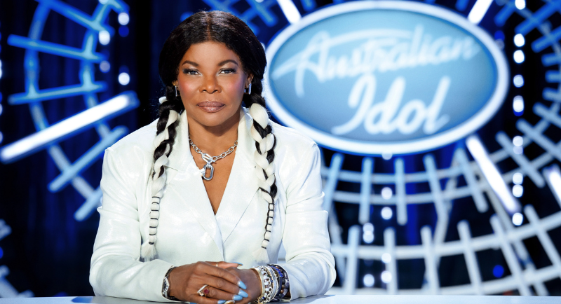 Marcia Hines sitting at desk