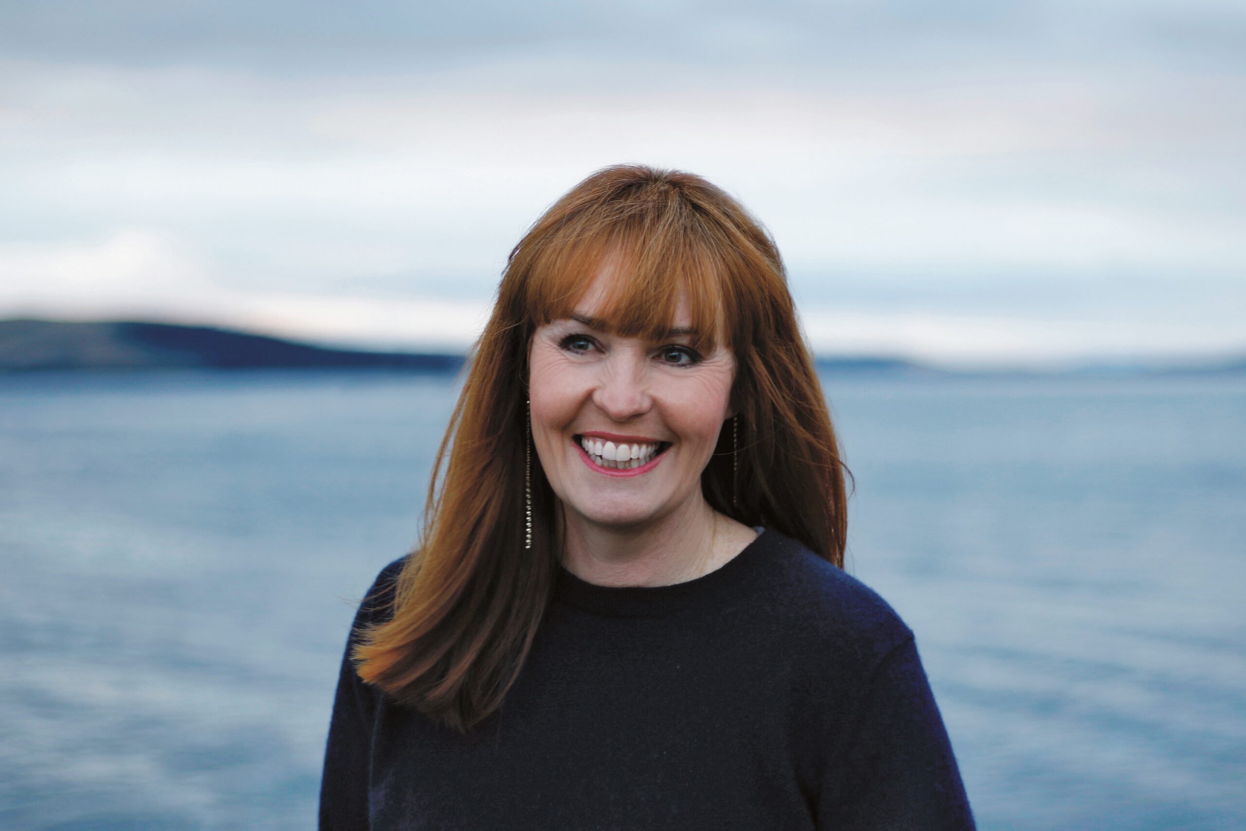 Kirsten Galliott standing in front of beach