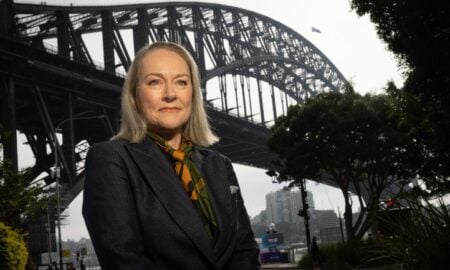 Moira Hogan stands in front of the Sydney Harbour Bridge