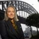Moira Hogan stands in front of the Sydney Harbour Bridge