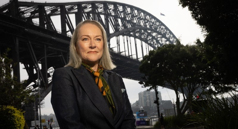Moira Hogan stands in front of the Sydney Harbour Bridge