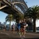Runners in a marathon passing under the Sydney Harbour Bridge