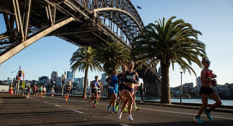 Runners in a marathon passing under the Sydney Harbour Bridge