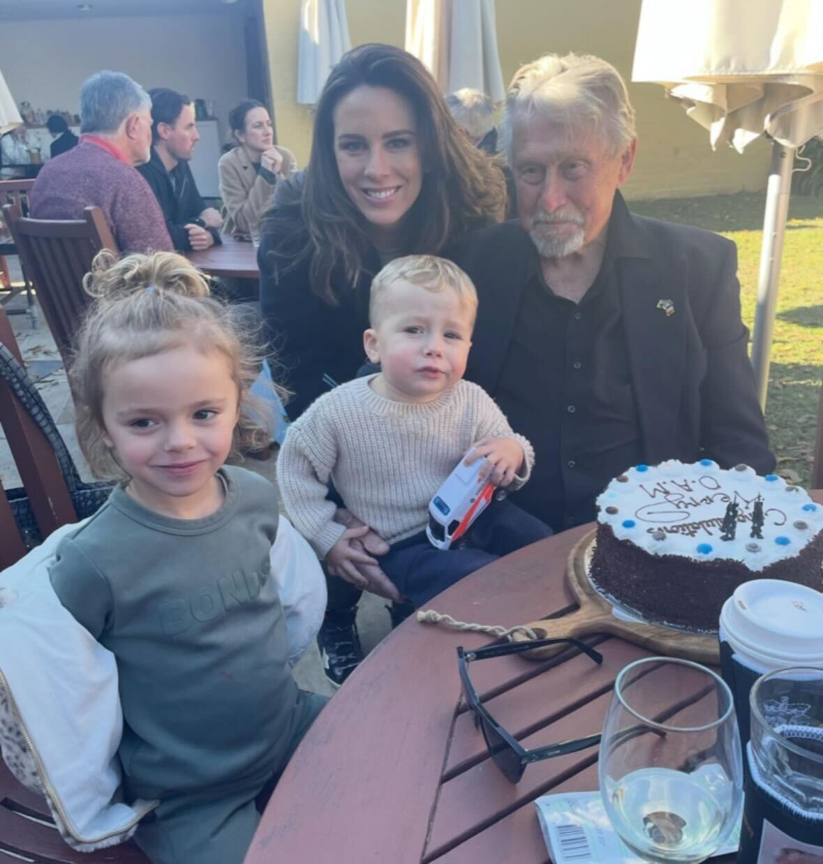 Laura and her children celebrate Terry's OAM.