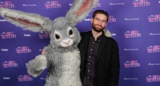 Tubi exec David Salmon stands alongside Tubi's rabbit mascot