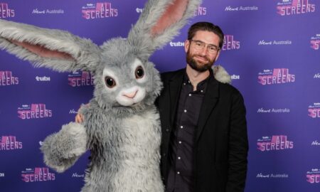 Tubi exec David Salmon stands alongside Tubi's rabbit mascot
