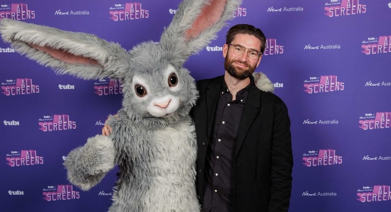 Tubi exec David Salmon stands alongside Tubi's rabbit mascot