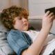 Kid watches YouTube on a phone