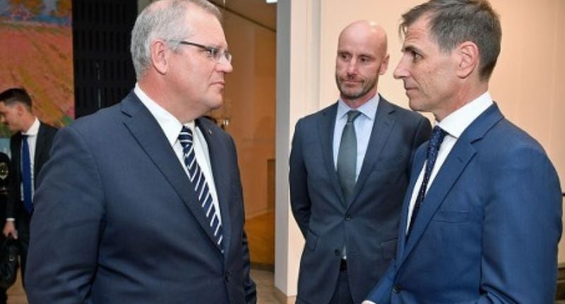Michael Wilkinson (centre) stands with former Prime Minister Scott Morrison and The Daily Telegraph's current Editor-in-Chief Ben English