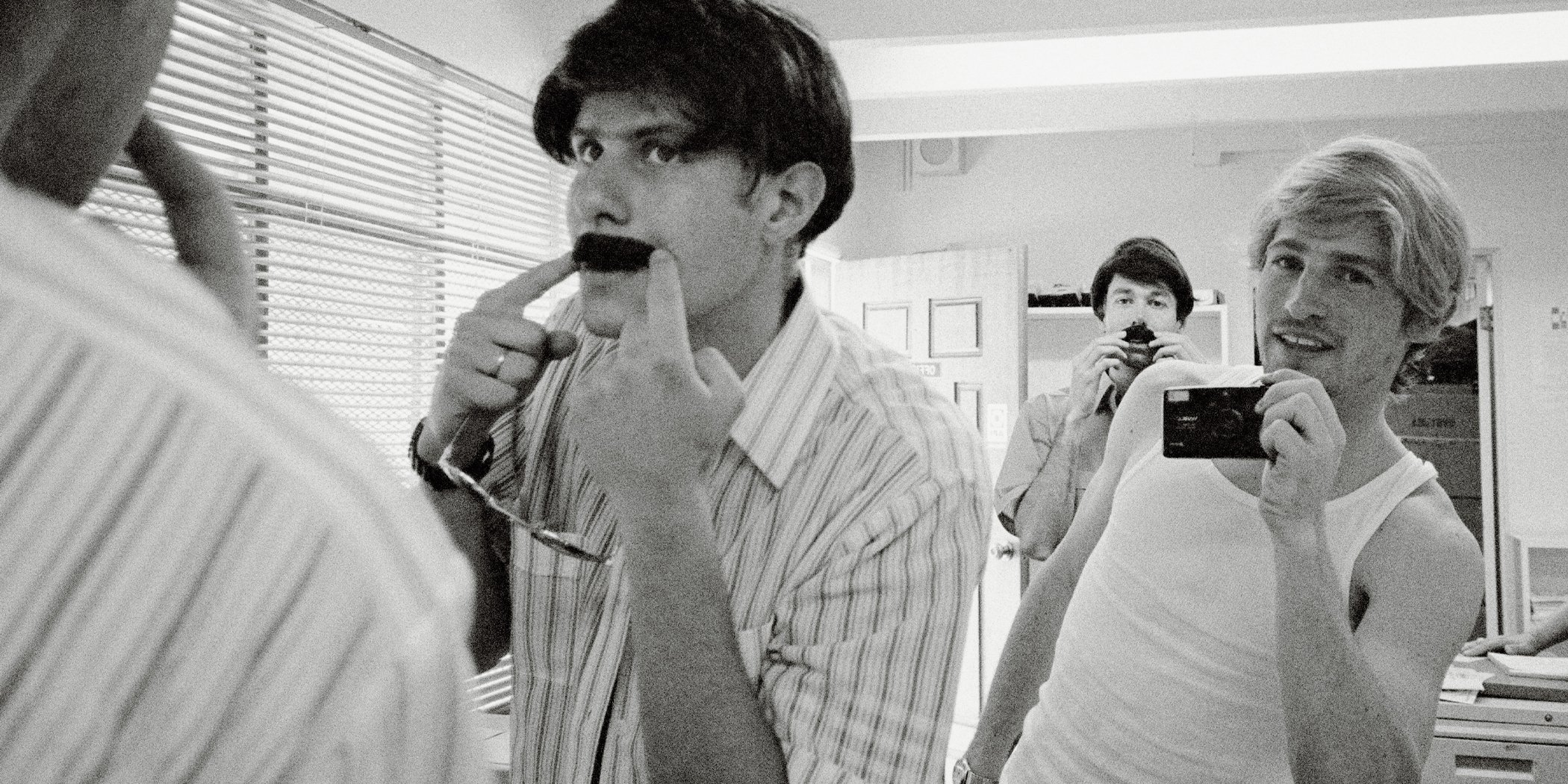 Behind the scenes photo of the Beastie Boys dressing up for the "Sabotage" film clip