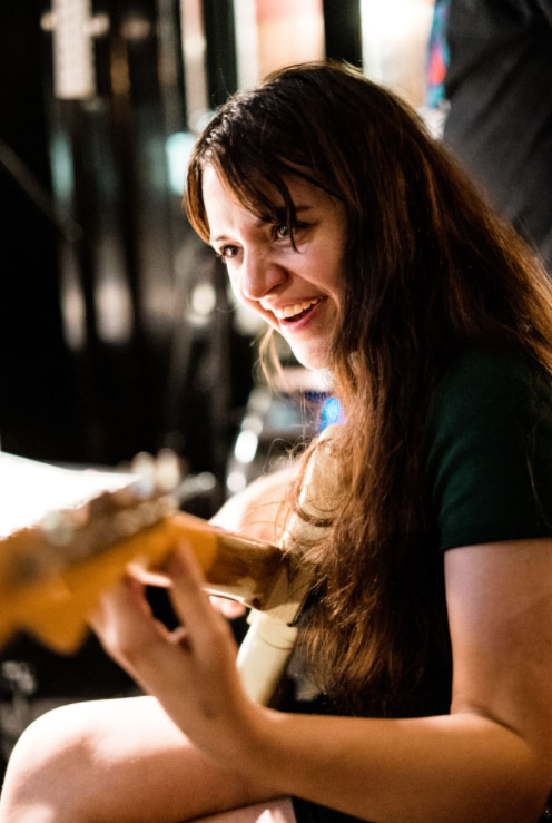Sophie Hopes of Tired Lion playing guitar during the recording of 'Breakfast for Pathetics'.