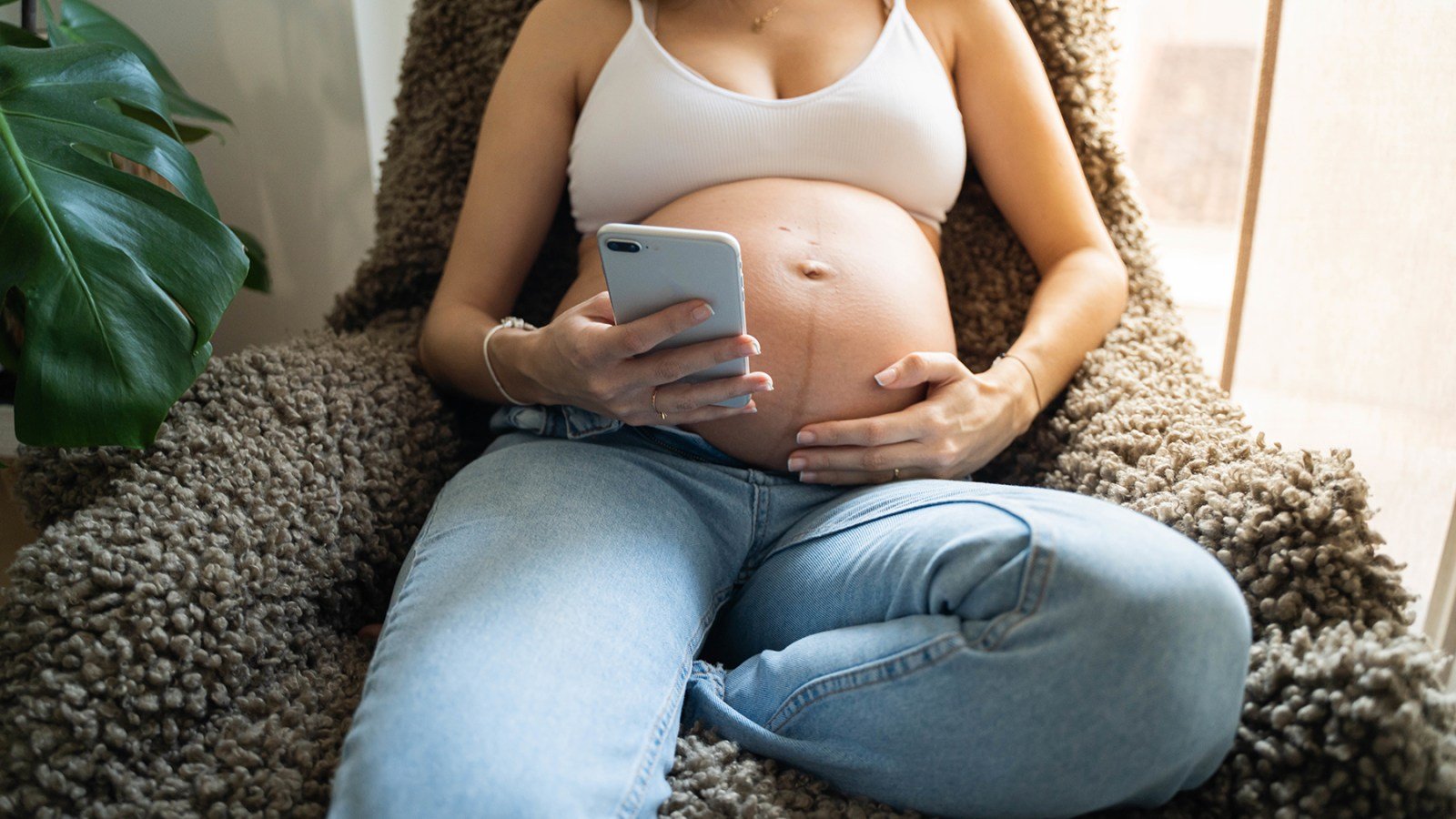 Pregnant woman on her phone
