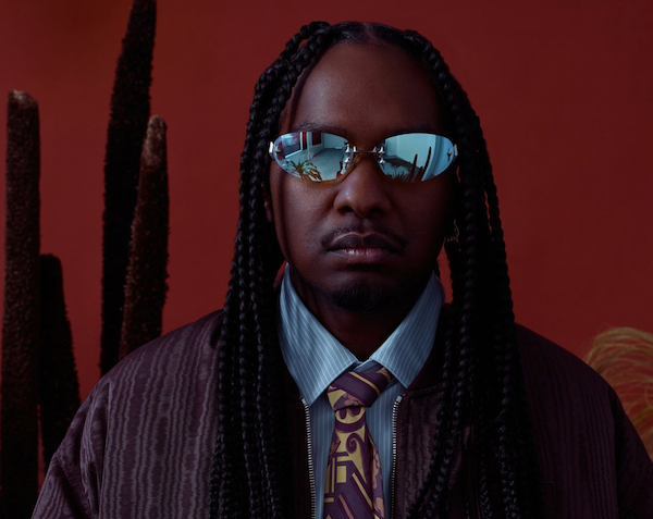 Baker Boy posing with sunglasses on