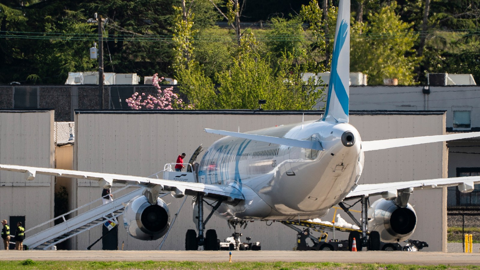 Detainees board a plane chartered by Immigration and Customs Enforcement (ICE) at King County International Airport in Seattle