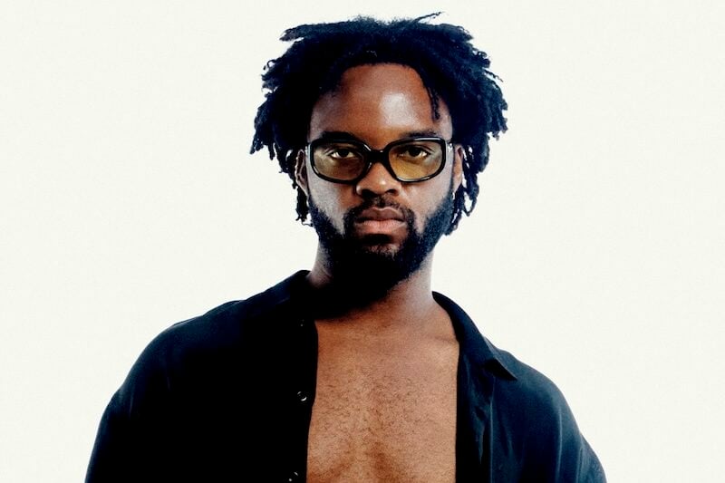 Genesis Owusu posing with sunglasses on