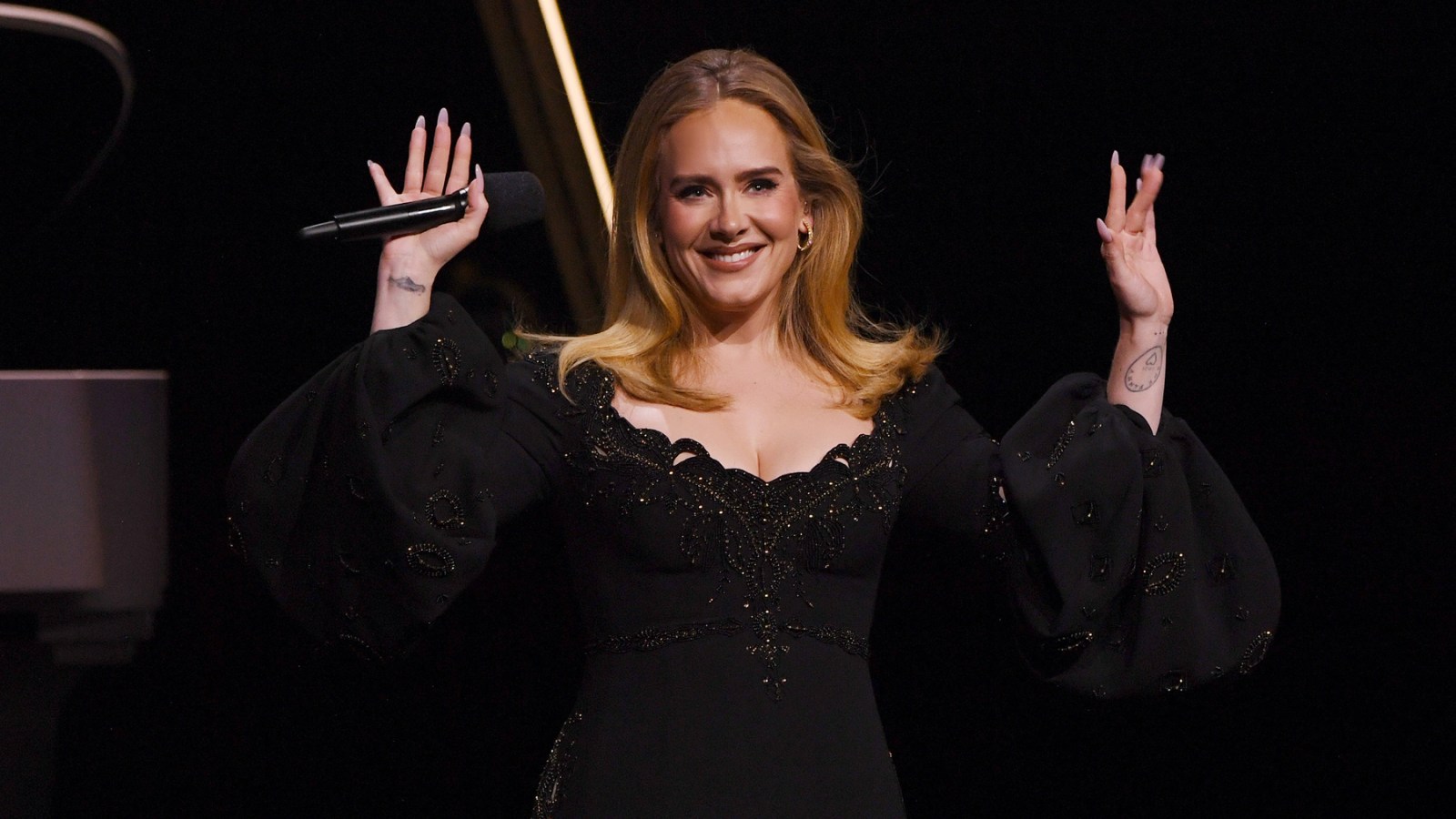 Adele waves at crowd