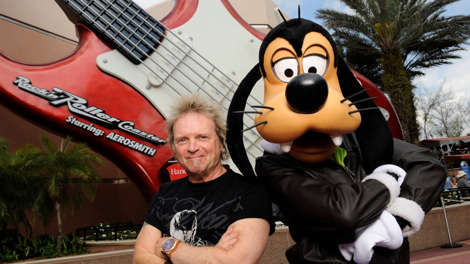 Aerosmith drummer Joey Kramer poses with Goofy