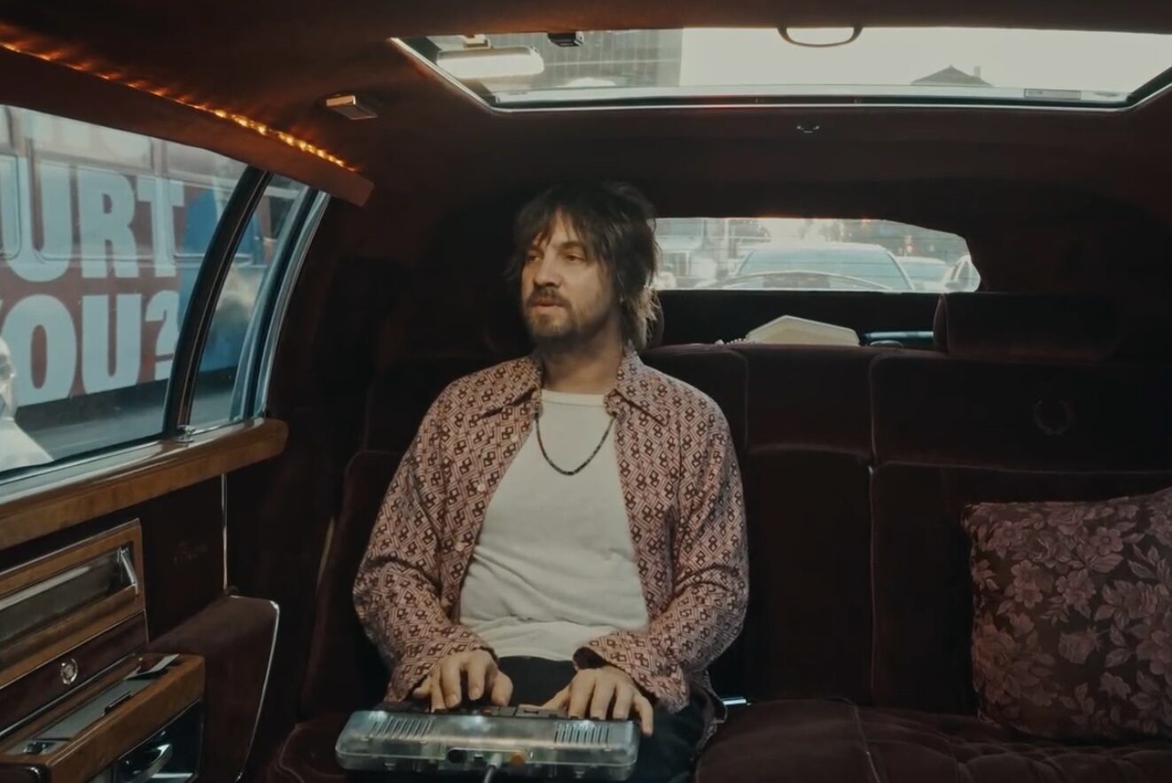 Tame Impala's Kevin Parker playing the Orchid in the back of a car