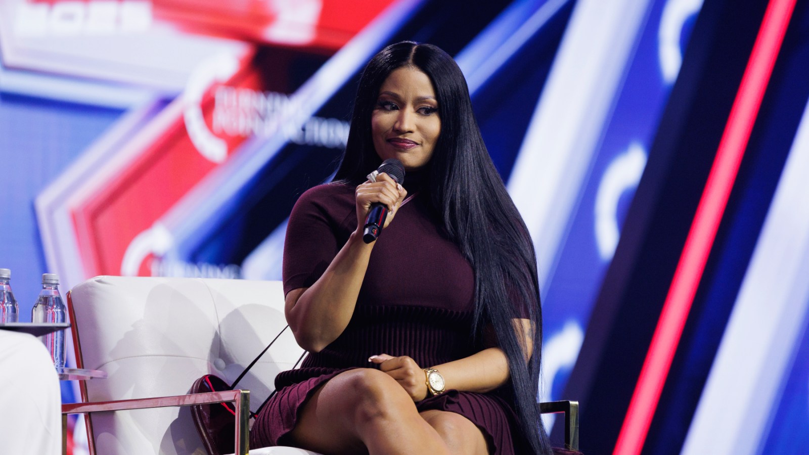 Nicki Minaj speaking at Turning Point USA's 2025 AmericaFest conference in Phoenix.