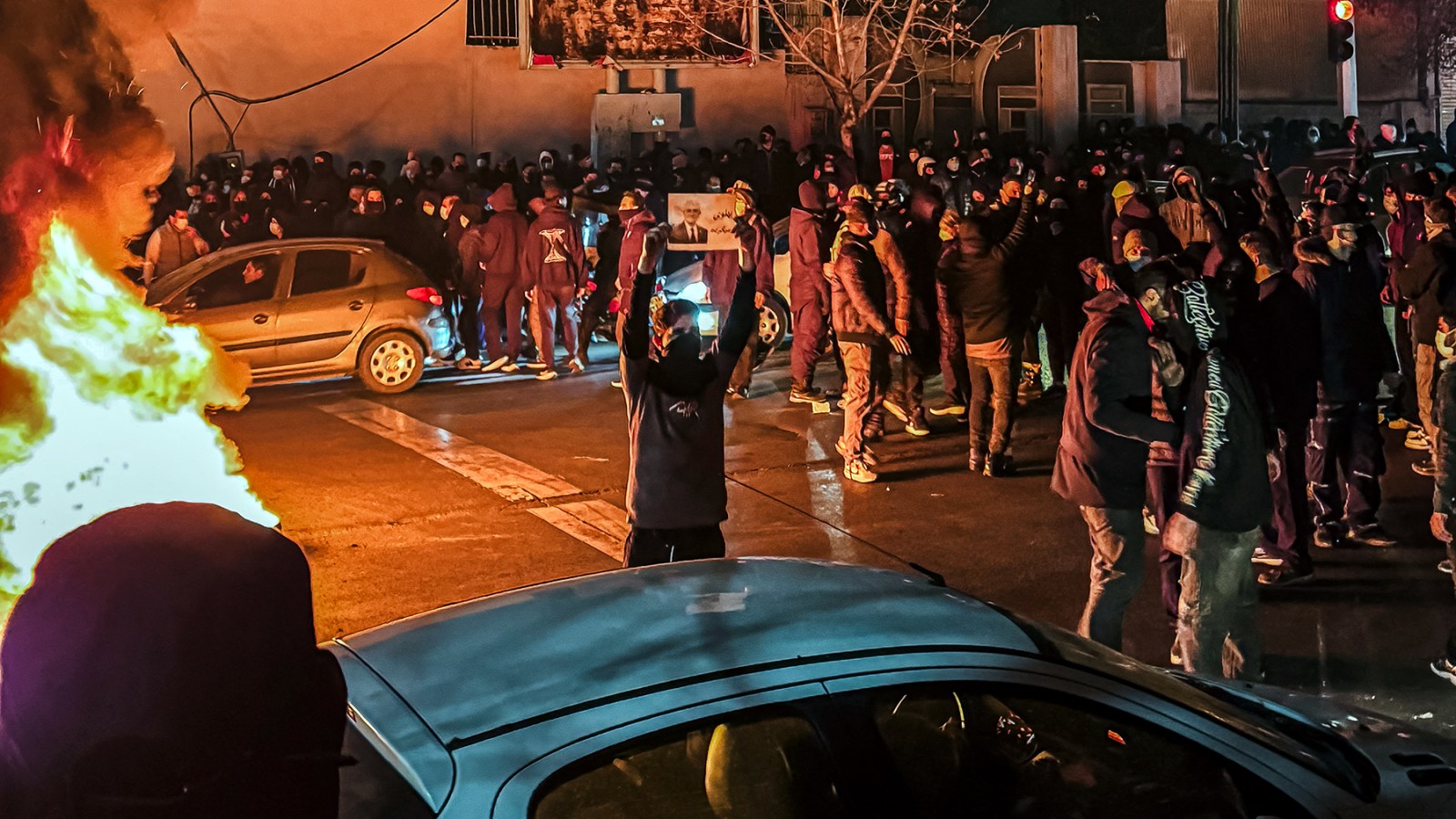Iranians gather while blocking a street during a protest in Tehran