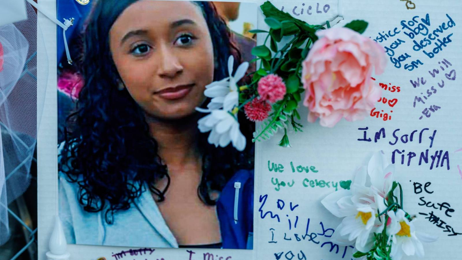 Photographs, notes, and flowers are among the items left at a memorial for Celeste Rivas Hernandez in Lake Elsinore.