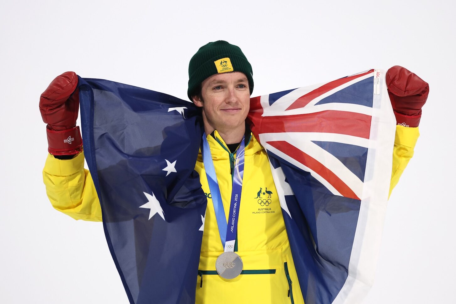 LIVIGNO, ITALY - FEBRUARY 13: Silver medalist Scotty James of Team Australia poses for a photo whilst holding the national flag of Australia during the medal ceremony for the Men's Snowboard Halfpipe on day seven of the Milano Cortina 2026 Winter Olympic games at Livigno Snow Park on February 13, 2026 in Livigno, Italy. (Photo by Cameron Spencer/Getty Images)
