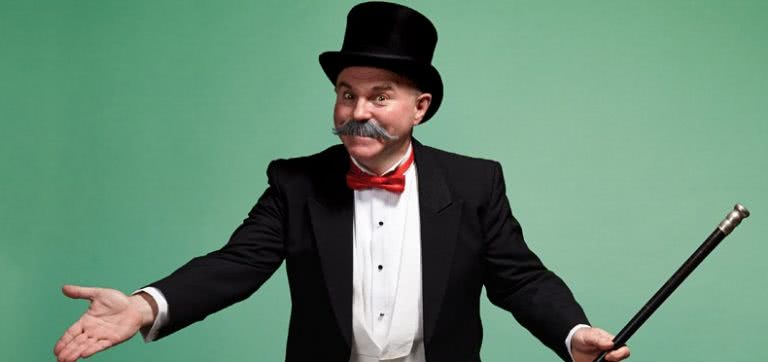 Moustached gentleman in a top hat, suit and red bowtie, carrying a cane on a mint green background