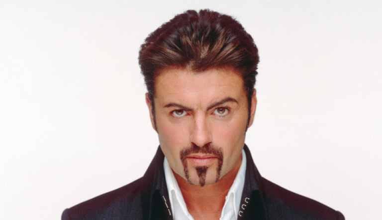 Pop music icon, George Michael with a goatee, white shirt and black jacket