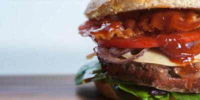Hamburger with bacon, swiss cheese, lettuce, tomato, meat patty, sesame seed bun at Burgapalooza