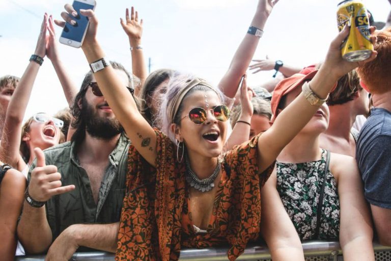 A young female music festival-goer enjoys the music