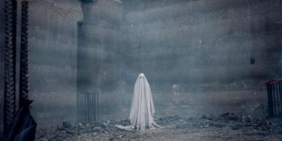 Actor Casey Affleck is dressed in a white bed sheet for A Ghost Story