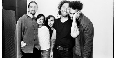 Gang Of Youths share an embrace in tasteful black and white.
