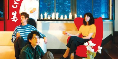 The cover of Tremolow, The Creases' debut album, in which the band members sit disaffectedly in a red loungeroom with lilies.
