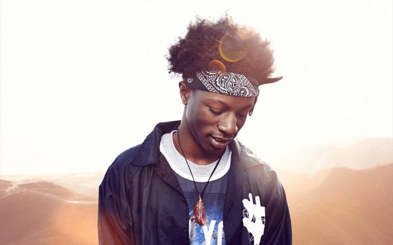Joey Bada$$ pictured responsibly staring away from the sun.