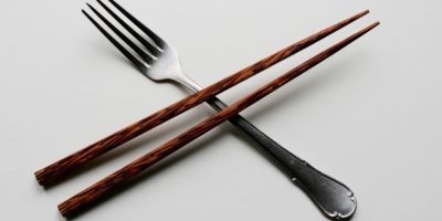 A pair of chopsticks crossing a fork.