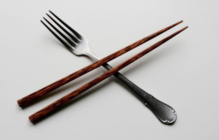 A pair of chopsticks crossing a fork.