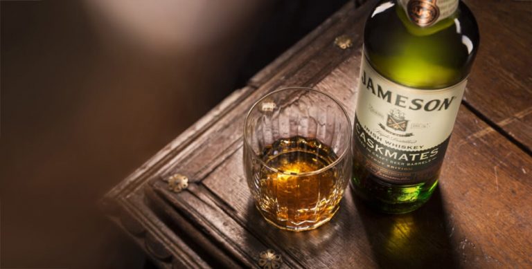 Bottle of Jameson whiskey next to glass