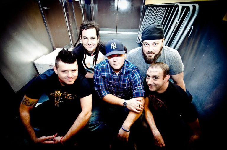 Less Than Jake sitting on some stairs