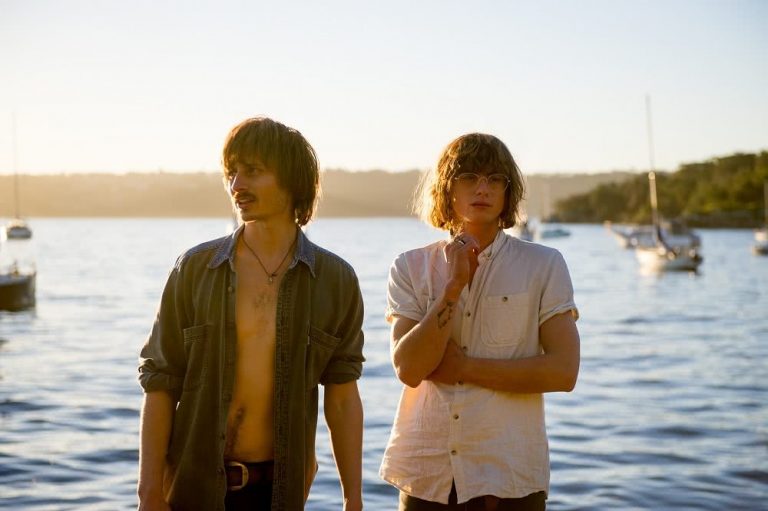 The two members of Lime Cordiale standing in front of the ocean