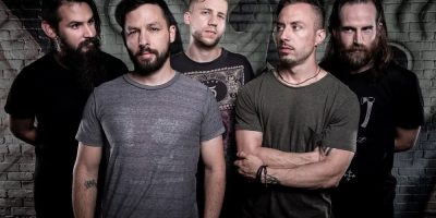 The members of the Dillinger Escape Plan in front of a wall