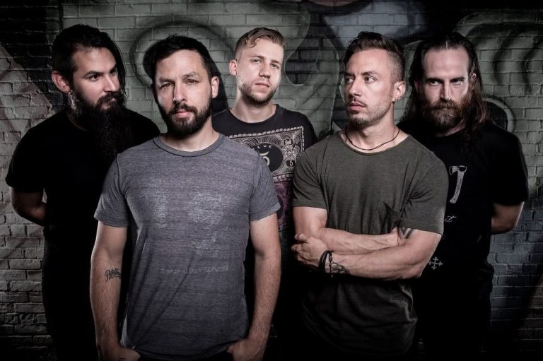 The members of the Dillinger Escape Plan in front of a wall