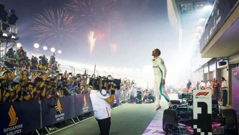A victorious Lewis Hamilton celebrates in parc ferme after winning the Formula 1 2018 Singapore Grand Prix