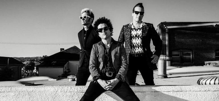 Black and white image of Green Day band members wearing sunglasses looking at camera