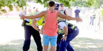 A man is searched for drugs at a music festival