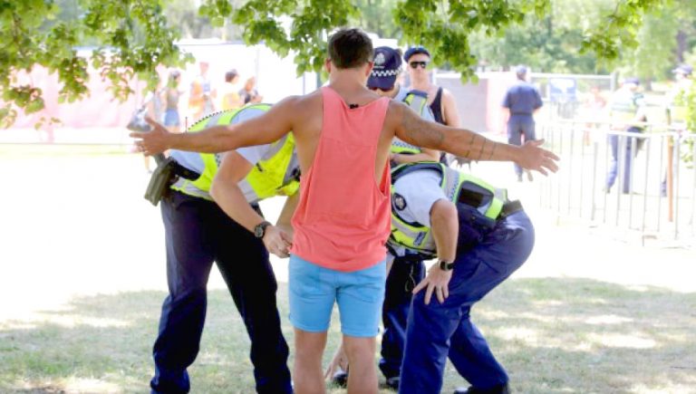A man is searched for drugs at a music festival
