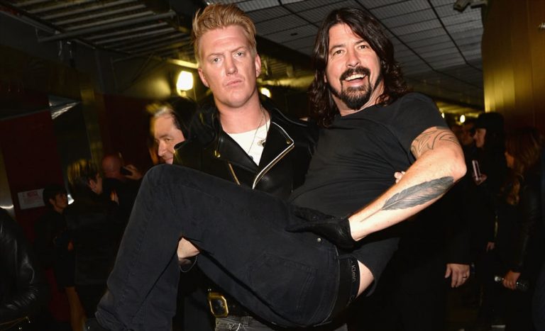 Queens Of The Stone Age's Josh Homme carrying Foo Fighters' Dave Grohl