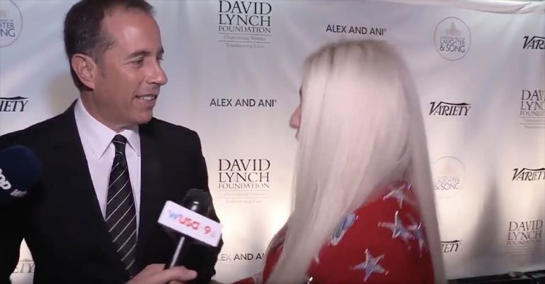 Jerry Seinfeld backing away from a hug from singer Kesha